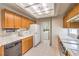 Functional kitchen with appliances, light wood cabinets, and tile floors at 8861 Hampton Green Ave, Las Vegas, NV 89129