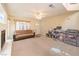 Spacious living room featuring a fireplace, ceiling fan, and lots of natural light at 8861 Hampton Green Ave, Las Vegas, NV 89129