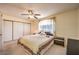 Neutral bedroom featuring a ceiling fan, sliding closet door and mirrored bedside table at 8861 Hampton Green Ave, Las Vegas, NV 89129