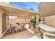 Covered patio featuring outdoor seating, a patio table, and a sun shade at 8861 Hampton Green Ave, Las Vegas, NV 89129