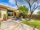 Backyard with outdoor seating, a patio, mature landscaping and artificial turf at 9037 Picket Fence Ave, Las Vegas, NV 89143