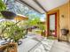 Charming backyard patio with hanging plants, shaded seating, and manicured lawn at 9037 Picket Fence Ave, Las Vegas, NV 89143