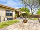 Beautiful backyard featuring a patio, artificial grass, and mature tree at 9037 Picket Fence Ave, Las Vegas, NV 89143