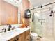 Stylish bathroom featuring an updated vanity, decorative mirror and tiled walk-in shower at 9037 Picket Fence Ave, Las Vegas, NV 89143