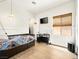 Comfortable bedroom features wood floors, a mounted TV, and window with shade at 9037 Picket Fence Ave, Las Vegas, NV 89143