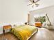 Sunny bedroom with wood floors, ceiling fan, large plant, and lots of natural light at 9037 Picket Fence Ave, Las Vegas, NV 89143