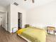 Comfortable bedroom includes wood floors, ceiling fan, an open closet and three drawer tables at 9037 Picket Fence Ave, Las Vegas, NV 89143