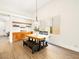 Well-lit dining room with a wooden table, bench seating, and a built-in cabinet and shelving unit at 9037 Picket Fence Ave, Las Vegas, NV 89143