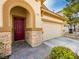 Close-up of the front entrance featuring a red door and decorative stone accents at 9037 Picket Fence Ave, Las Vegas, NV 89143
