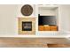 Living room fireplace with a unique stone surround and built-in shelving for a TV at 9037 Picket Fence Ave, Las Vegas, NV 89143