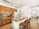 Kitchen showcasing granite counters, wooden cabinets, and a center island with bar stool seating at 9037 Picket Fence Ave, Las Vegas, NV 89143