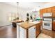 Well-lit kitchen with granite counters and open floor plan leading to the dining area at 9037 Picket Fence Ave, Las Vegas, NV 89143