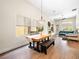 Bright living room with a wood dining table, large windows, and a comfortable sofa at 9037 Picket Fence Ave, Las Vegas, NV 89143