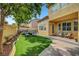 Picturesque backyard with lush lawn, seating area, and mature trees creating a tranquil setting at 9413 Artesian Oak Ct, Las Vegas, NV 89149