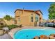 Backyard oasis featuring a sparkling pool, lush landscaping, and ample space for recreation at 9413 Artesian Oak Ct, Las Vegas, NV 89149