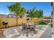 Well-maintained backyard with patio seating, barbecue, and manicured landscaping at 9413 Artesian Oak Ct, Las Vegas, NV 89149