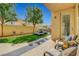 Inviting backyard featuring a patio area, a well-maintained lawn, and a refreshing pool, perfect for outdoor living at 9413 Artesian Oak Ct, Las Vegas, NV 89149