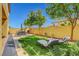 Inviting backyard oasis with lush green lawn, patio furniture, and relaxing lounge chairs at 9413 Artesian Oak Ct, Las Vegas, NV 89149