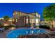 Backyard featuring a swimming pool with a rock waterfall feature, an artificial lawn, and covered patio area at 9413 Artesian Oak Ct, Las Vegas, NV 89149