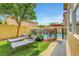 Beautiful backyard featuring a pool, waterfall feature, and lounge area for relaxation at 9413 Artesian Oak Ct, Las Vegas, NV 89149