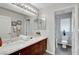 Stylish bathroom featuring double sinks, elegant mirrors, and modern fixtures, offering a luxurious and functional space at 9413 Artesian Oak Ct, Las Vegas, NV 89149