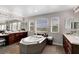 An airy bathroom featuring a soaking tub, dual sinks, a makeup vanity, and bright natural light at 9413 Artesian Oak Ct, Las Vegas, NV 89149
