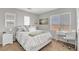 Bright bedroom with a comfortable bed, a work desk, and scenic views from the window, creating an inviting space at 9413 Artesian Oak Ct, Las Vegas, NV 89149
