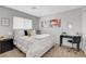 Inviting bedroom featuring a plush bed, black desk, and modern decor, creating a relaxing and stylish retreat at 9413 Artesian Oak Ct, Las Vegas, NV 89149