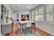 Bright dining room with a modern table set, shutters, and stylish decor at 9413 Artesian Oak Ct, Las Vegas, NV 89149