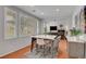 Modern dining space with a marble top table and an open view of the living room at 9413 Artesian Oak Ct, Las Vegas, NV 89149