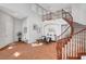 A grand foyer with a curved staircase, high ceilings, and tile floors at 9413 Artesian Oak Ct, Las Vegas, NV 89149