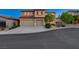 Charming two-story home with a well-manicured front yard and a three-car garage at 9413 Artesian Oak Ct, Las Vegas, NV 89149