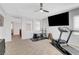 This room is set up perfectly as a home gym with a ceiling fan, TV, and various workout equipment at 9413 Artesian Oak Ct, Las Vegas, NV 89149