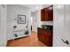 A small table sits against the wall in this hallway with dark wood cabinets to the side at 9413 Artesian Oak Ct, Las Vegas, NV 89149
