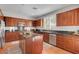 Stylish kitchen with stainless steel appliances, granite countertops, and dark wood cabinets at 9413 Artesian Oak Ct, Las Vegas, NV 89149