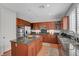 Gourmet kitchen featuring stainless steel appliances, center island, and granite countertops at 9413 Artesian Oak Ct, Las Vegas, NV 89149