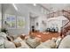 Spacious living room with high ceilings, shutters, tile floors and a staircase at 9413 Artesian Oak Ct, Las Vegas, NV 89149
