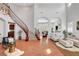Elegant living room featuring a staircase, tile flooring, archways, and neutral decor with lots of natural light at 9413 Artesian Oak Ct, Las Vegas, NV 89149