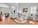 Bright living room with neutral decor, tile floors, and comfortable seating arrangement at 9413 Artesian Oak Ct, Las Vegas, NV 89149