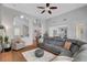 Open concept living room with vaulted ceilings, tile floors, and modern sofa at 9413 Artesian Oak Ct, Las Vegas, NV 89149