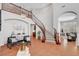 Bright living room showcasing a grand staircase, tile flooring, high ceilings, and neutral decor with contemporary furniture at 9413 Artesian Oak Ct, Las Vegas, NV 89149