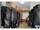 Spacious walk-in closet with abundant shelving, storage boxes and hanging space, offering practical organization solutions at 9413 Artesian Oak Ct, Las Vegas, NV 89149