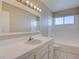 Bathroom with vanity, mirror, tiled counter, and white tiled bathtub shower at 125 Sam Jonas Dr, Las Vegas, NV 89145