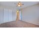 Spacious bedroom with carpet, ceiling fan, closet, and neutral wall paint at 125 Sam Jonas Dr, Las Vegas, NV 89145