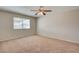 Cozy bedroom with neutral carpet, window, and ceiling fan at 125 Sam Jonas Dr, Las Vegas, NV 89145