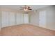 Spacious bedroom featuring plush carpet, ceiling fan and ample closet space at 125 Sam Jonas Dr, Las Vegas, NV 89145