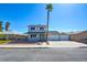 Charming two-story home with a well-maintained front yard, long driveway, and a grand palm tree in the front at 125 Sam Jonas Dr, Las Vegas, NV 89145