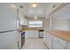 Functional kitchen featuring white cabinetry, black appliances, and wood-look countertops at 125 Sam Jonas Dr, Las Vegas, NV 89145