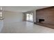Bright living room with tile flooring, dark fireplace, sliding door access to the backyard, and neutral walls at 125 Sam Jonas Dr, Las Vegas, NV 89145