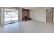 Spacious living room with tile flooring, dark fireplace, sliding door access to the backyard, and neutral walls at 125 Sam Jonas Dr, Las Vegas, NV 89145